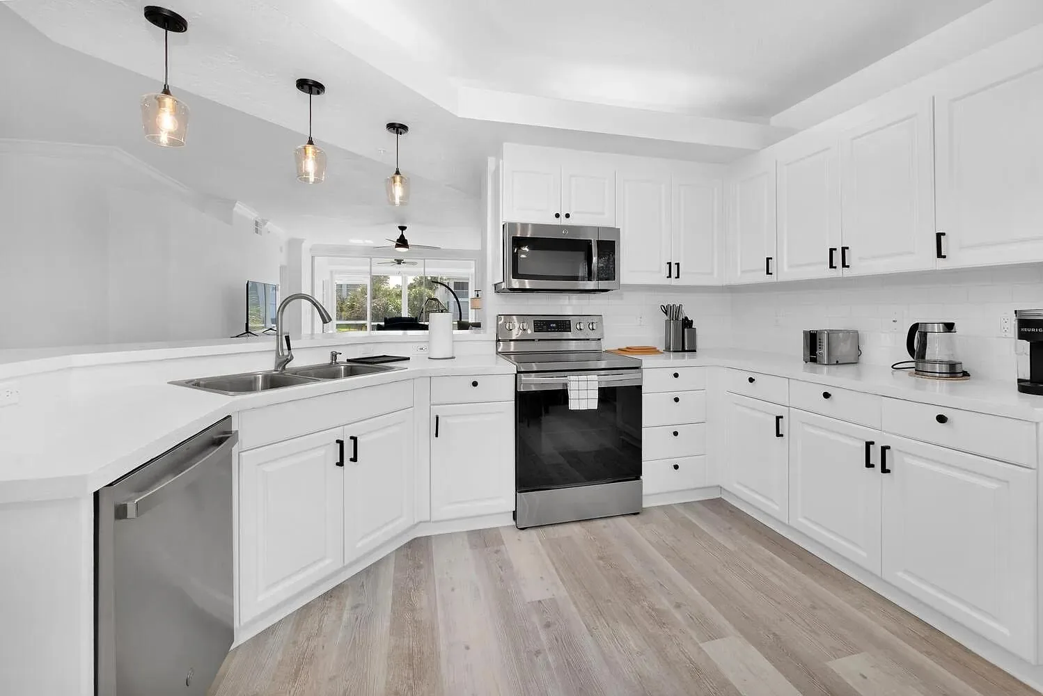 White kitchen with stainless steel appliances in Naples furnished rental