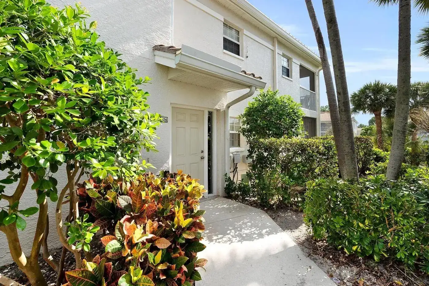 Private first floor entry with tropical landscaping